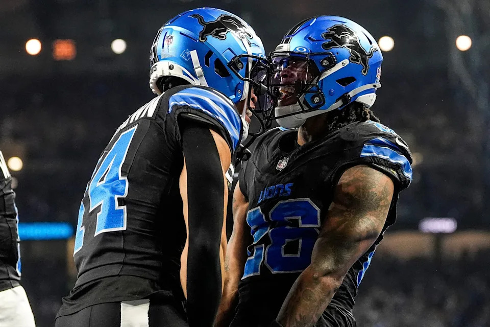 Detroit Lions running back Jahmyr Gibbs (26), right, celebrates a touchdown against Minnesota Vikings with wide receiver Amon-Ra St. Brown (14) during the first half at Ford Field in Detroit on Sunday, Jan. 5, 2025.