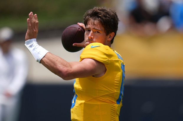 Chargers quarterback Justin Herbert throws a pass during a training...