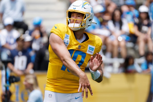 Chargers quarterback Justin Herbert throws a pass during a practice...