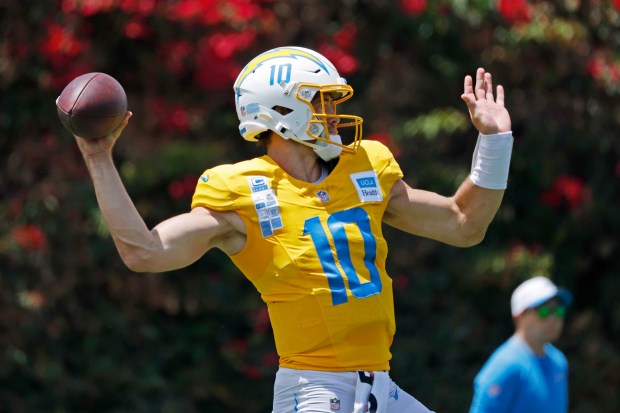 Chargers quarterback Justin Herbert throws a pass during a practice...