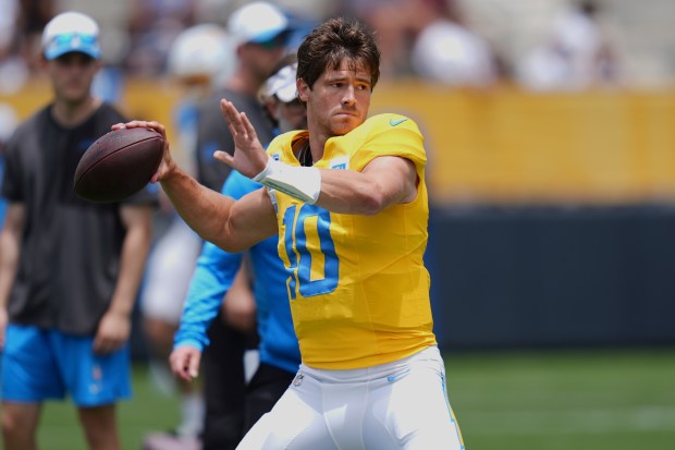 Chargers quarterback Justin Herbert throws a pass during a training...