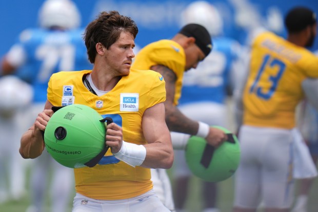 Chargers quarterback Justin Herbert goes through a drill during a...