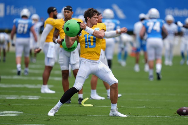 Chargers quarterback Justin Herbert goes through a drill during a...