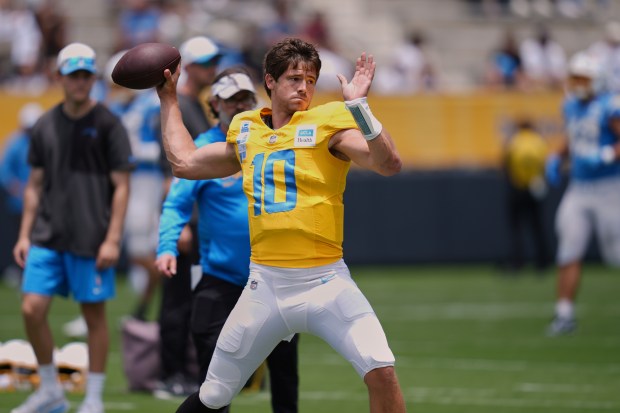 Chargers quarterback Justin Herbert throws a pass during a training...