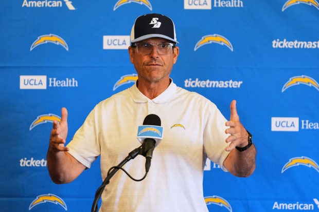 Chargers head coach Jim Harbaugh speaks to reporters during a...
