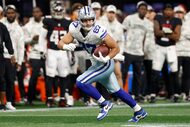 Dallas Cowboys tight end Jake Ferguson (87) looks up field after making a catch during the...