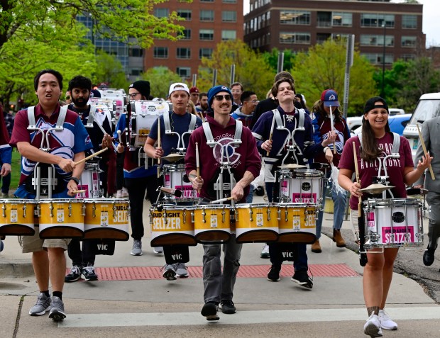The Colorado Avalanche Celly Squad drum line and fans make their way to Ball Arena from Larimer Square before the Avalanche play the Winnipeg Jets in game three of the first round NHL playoffs at Ball Arena in Denver on Friday, April 26, 2024. (Photo by Andy Cross/The Denver Post)