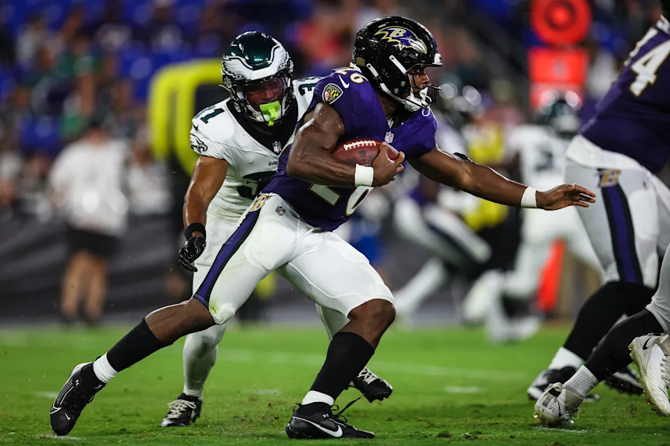 BALTIMORE, MD - AUGUST 09: Rasheen Ali #26 of the Baltimore Ravens carries the ball as Tyler Hall #31 of the Philadelphia Eagles defends during the second half of a preseason game at M&T Bank Stadium on August 9, 2024 in Baltimore, Maryland. (Photo by Scott Taetsch/Getty Images)