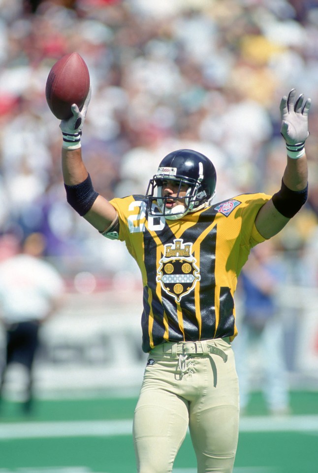 Rod Woodson #26 of the Pittsburgh Steelers in a throwback 1933 jersey celebrating after a play.