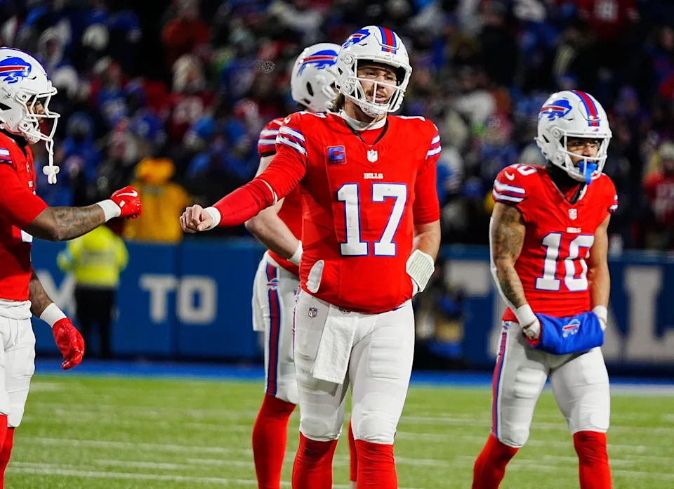 Buffalo Bills running back James Cook (4) and Buffalo Bills quarterback Josh Allen (17) fist bump after a play during second half action at Highmark Stadium where the Buffalo Bills hosted the New England Patriots in Orchard Park on Dec. 22, 2024.