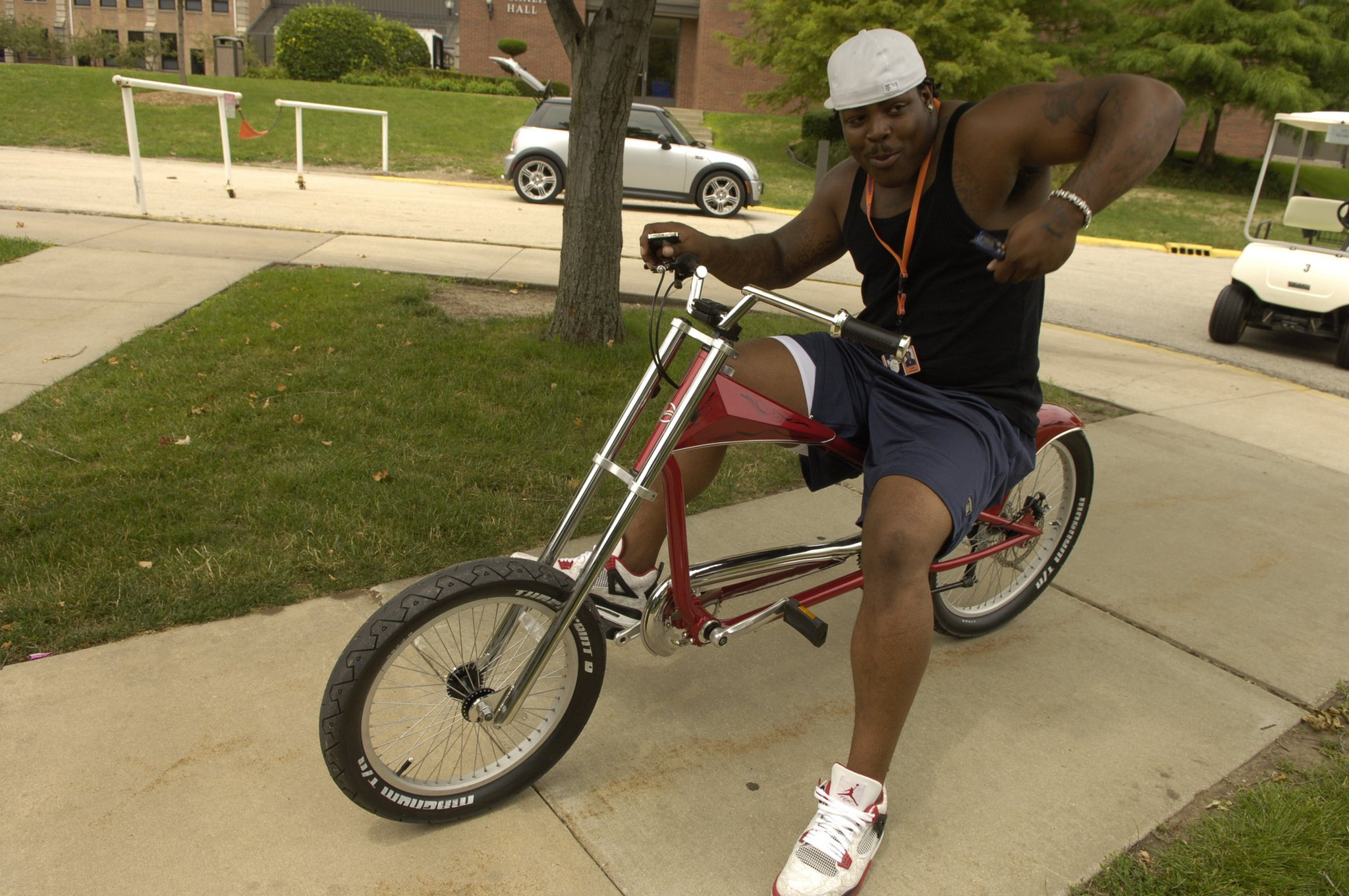 Bears defensive tackle Tank Johnson pretends to pull start his bicycle while riding around campus in 2005.