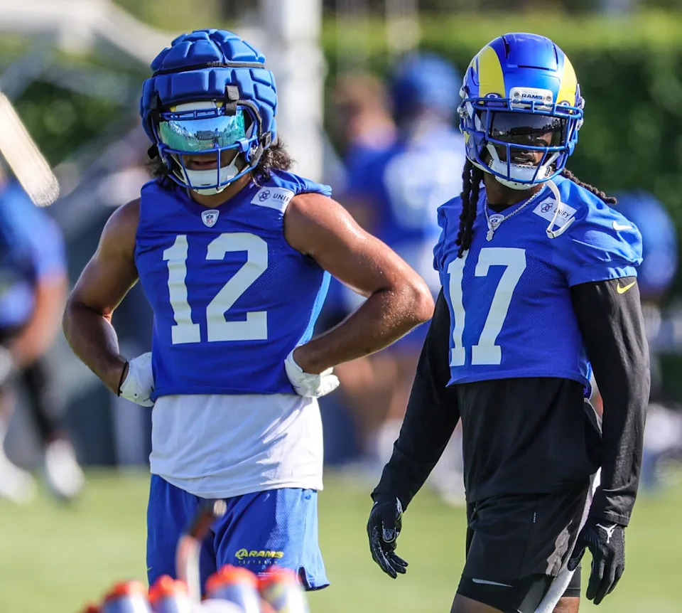 Rams receivers Puka Nacua, left, and Davante Adams prepare for a drill during training camp on Wednesday.