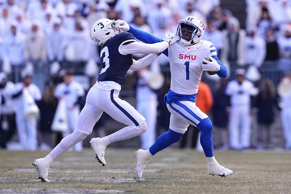 STATE COLLEGE, PENNSYLVANIA - DECEMBER 21: Brashard Smith #1 of the Southern Methodist Mustangs runs the ball against Jalen Kimber #3 of the Penn State Nittany Lions during the first quarter in the Playoff First Round Game at Beaver Stadium on December 21, 2024 in State College, Pennsylvania. (Photo by Mitchell Leff/Getty Images)