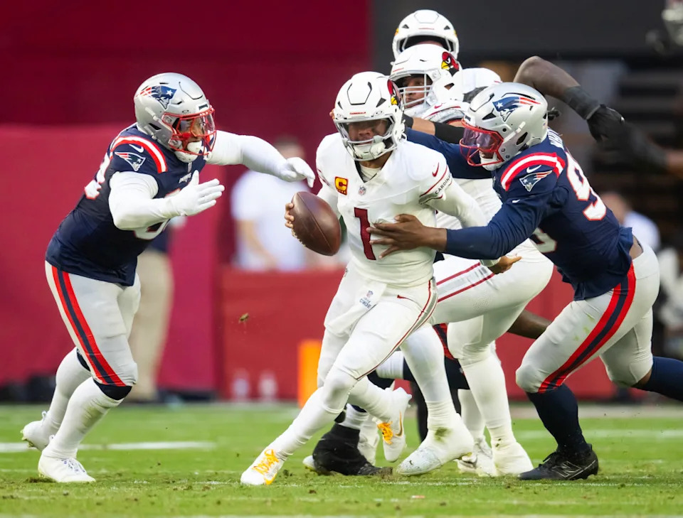 Arizona Cardinals quarterback Kyler Murray (1) is sacked by New England Patriots defensive end Keion White (99) and linebacker Anfernee Jennings (33) in the first half at State Farm Stadium.Mark J. Rebilas-Imagn Images