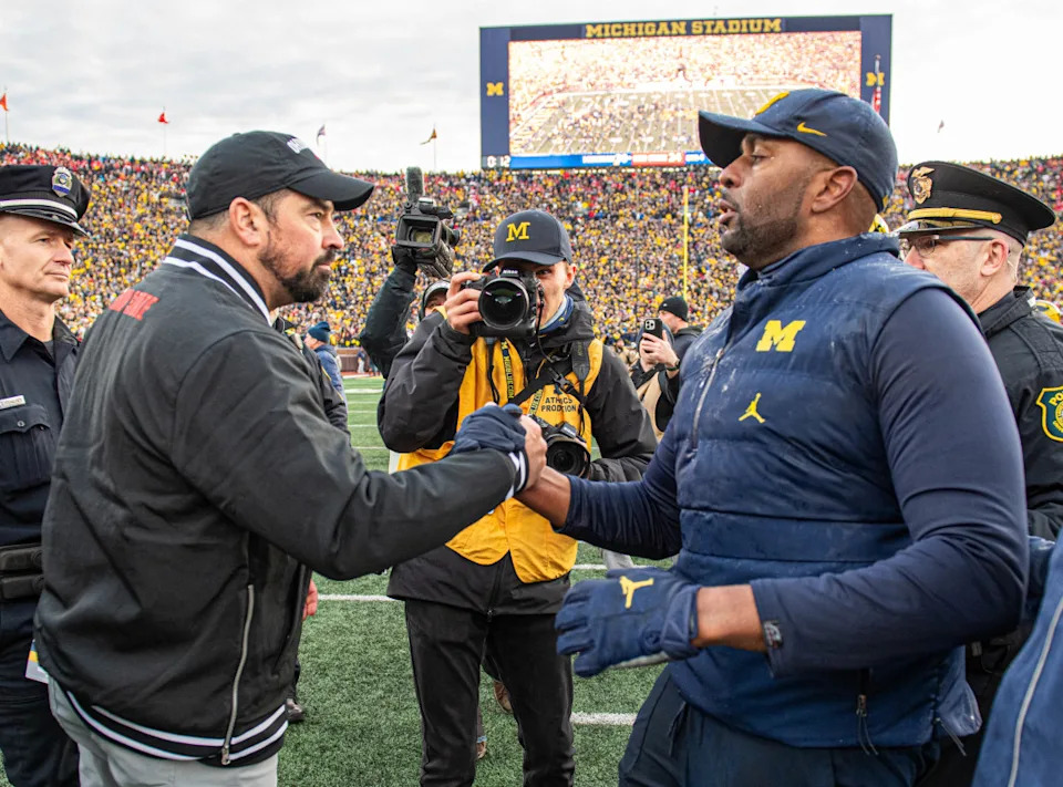 ANN ARBOR, MICHIGAN - NOVEMBER 25: Head Football Coaches Ryan Day (L) of the Ohio State Buckeyes and Sherrone Moore (R) of the Michigan Wolverines shake hands after a college football game at Michigan Stadium on November 25, 2023 in Ann Arbor, Michigan. The Michigan Wolverines won the game 30-24 to win the Big Ten East. (Photo by Aaron J. Thornton/Getty Images)Aaron J&period; Thornton&sol;Getty Images