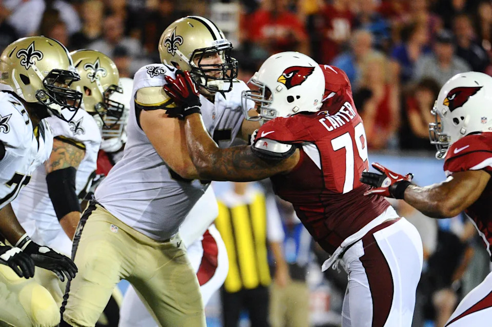Aug 5, 2012; New Orleans Saints center Matt Tennant (65) blocks against the Arizona Cardinals. Mandatory Credit: Tim Fuller-Imagn Images