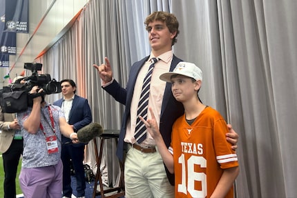 Texas quarterback Arch Manning meets super-fan Connor Petroziello, 13, at SEC Media Days in...