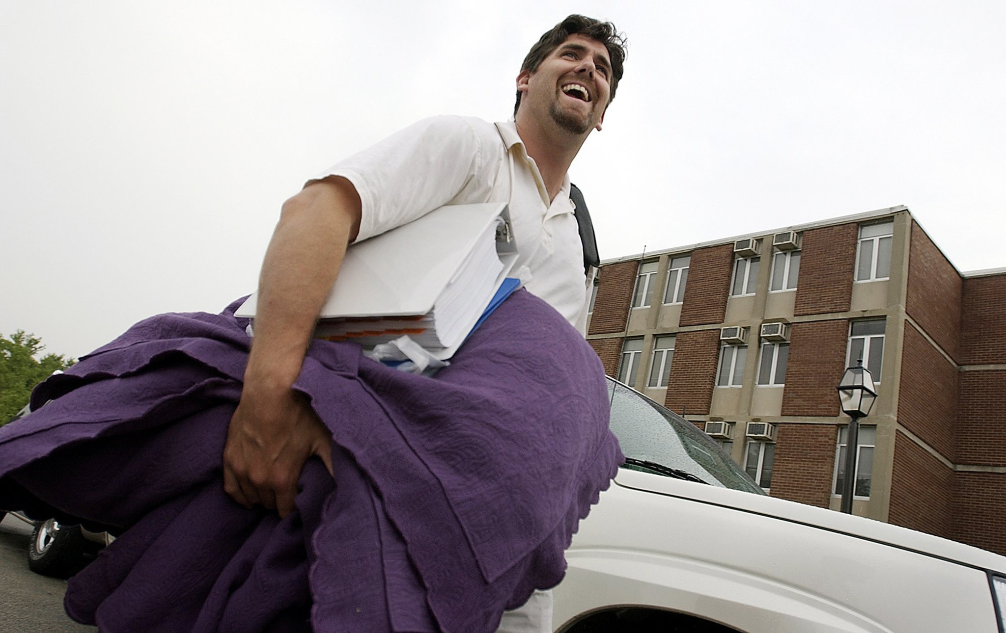 Quarterback Jim Miller arrives with a binder and some linens in 2002.
