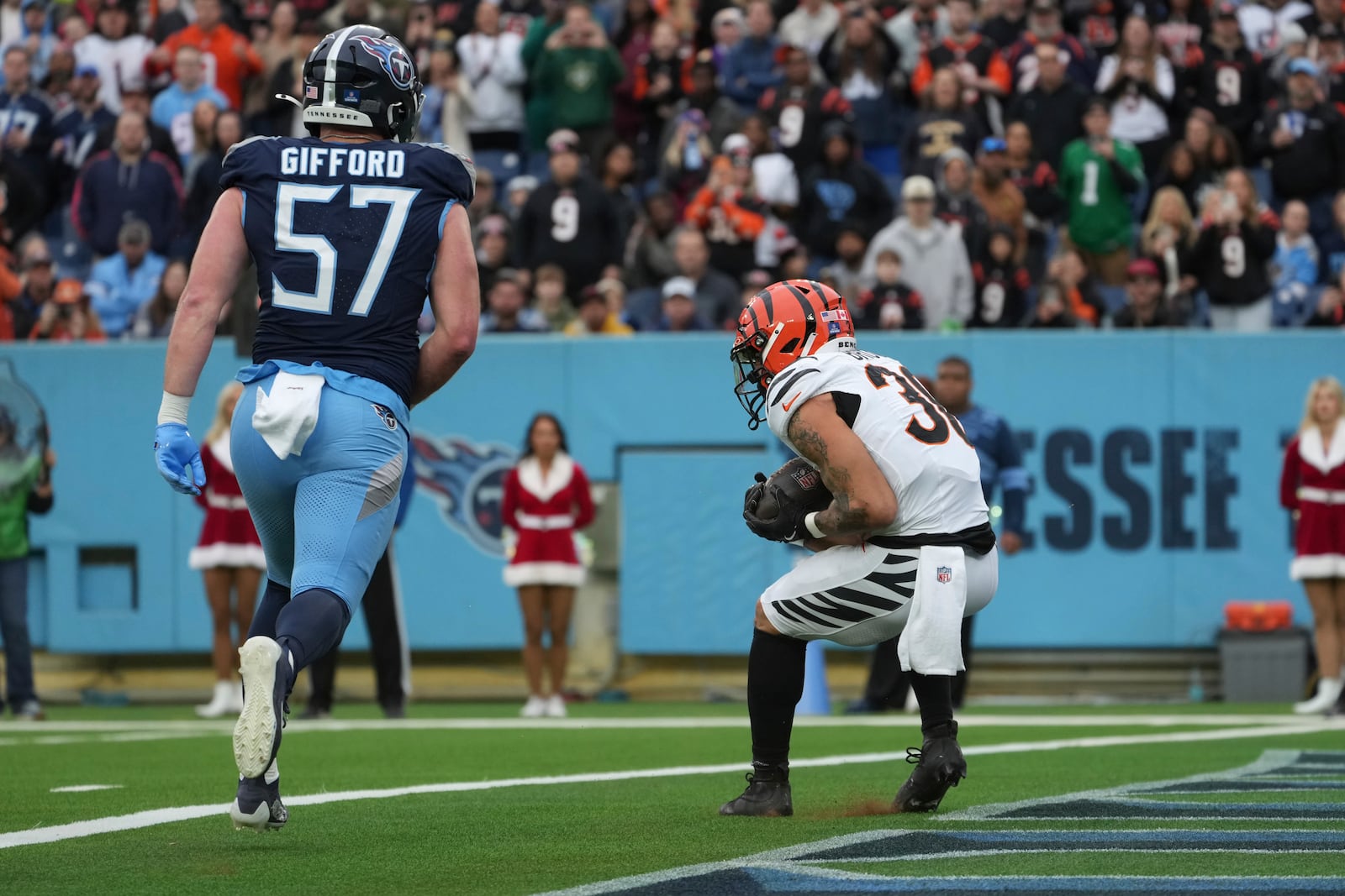 Cincinnati Bengals running back Chase Brown (30) catches a touchdown pass during the first half of an NFL football game against the Tennessee Titans, Sunday, Dec. 15, 2024, in Nashville, Tenn. (AP Photo/George Walker IV)