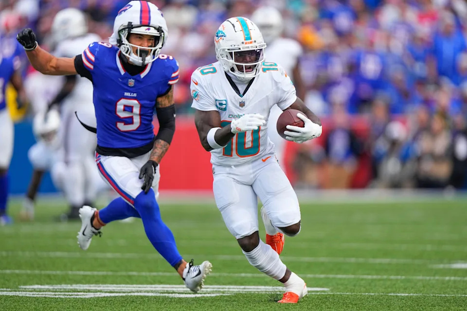 Miami Dolphins wide receiver Tyreek Hill (10) runs with the ball against Buffalo Bills safety Taylor Rapp (9) during the second half at Highmark Stadium in Orchard Park on Nov. 3, 2024.