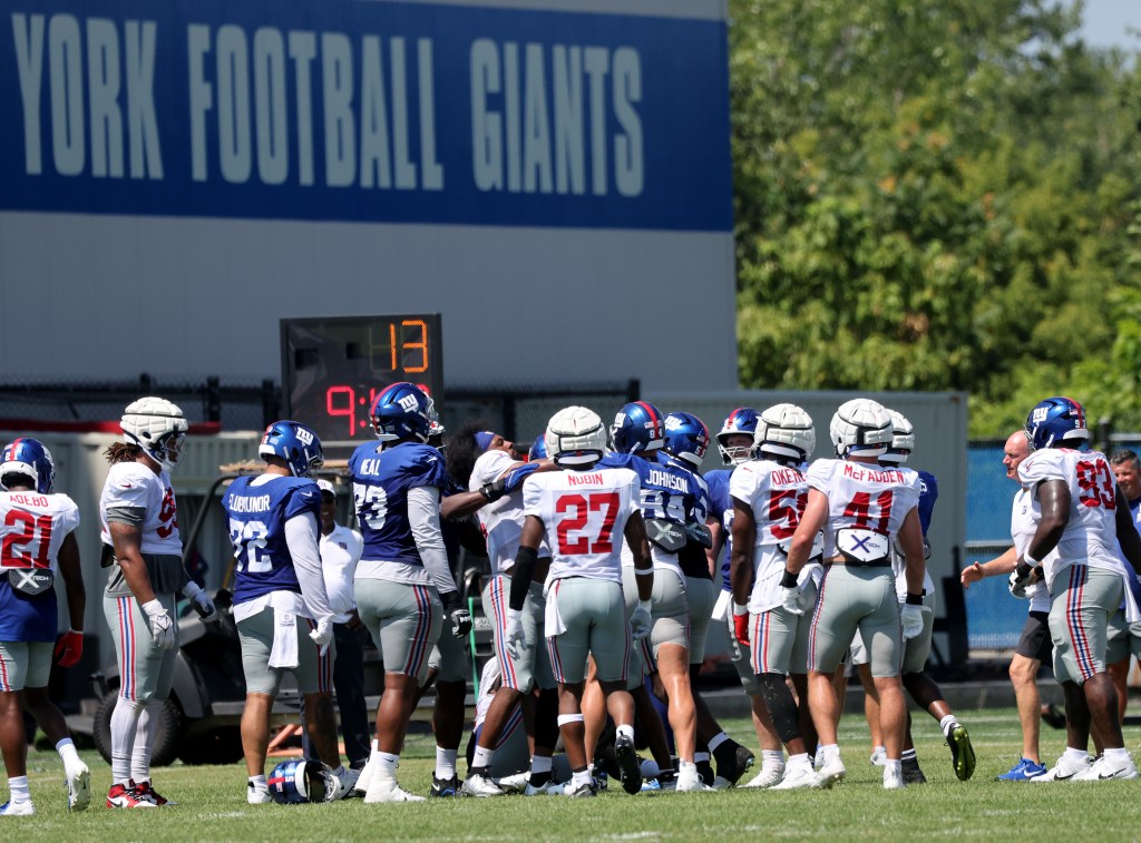New York Giants players huddle during practice.