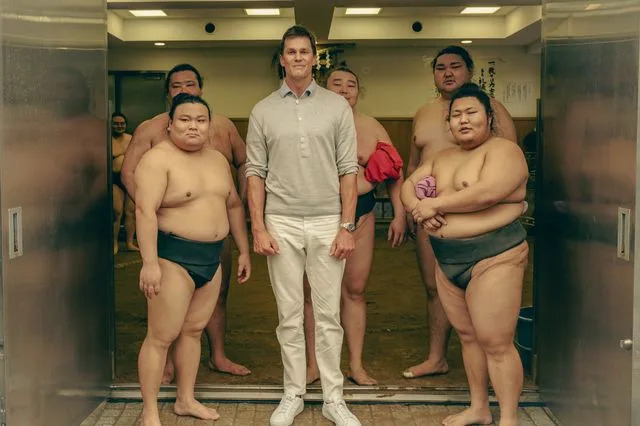 Tom Brady Posing with the sumo fighters in Japan after watching them in action.