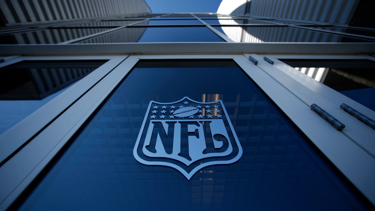 The NFL logo appears on an entrance door to the football stadium at Super Bowl XLII in Glendale, Arizona February 2, 2008. New England Patriots will play the New York Giants in the NFL's Super Bowl XLII football game at the stadium on Sunday. REUTERS/Mike Blake (UNITED STATES) - RTR1WL8P