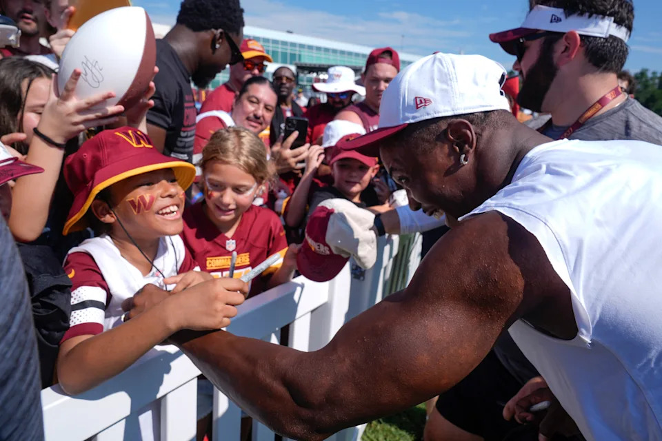Washington Commanders wide receiver Terry McLaurin signs autographs for fans after a practice at the team's NFL football training camp, Sunday, July 27, 2025, in Ashburn, Va. (AP Photo/Mark Schiefelbein)