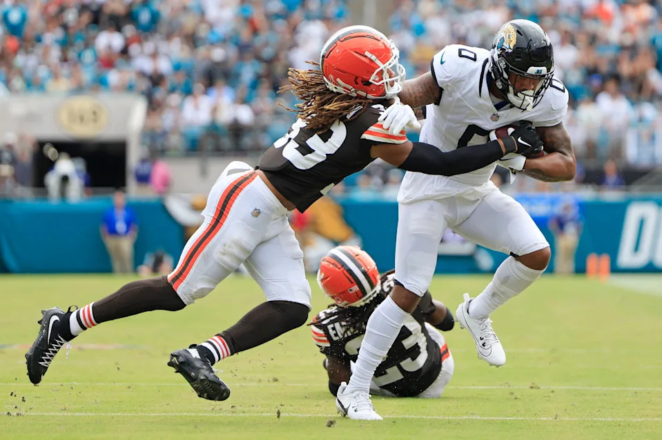 Cleveland Browns safety Ronnie Hickman (33) tackles Jacksonville Jaguars wide receiver Gabe Davis (0) on Sept. 15, 2024, in Jacksonville, Fla.