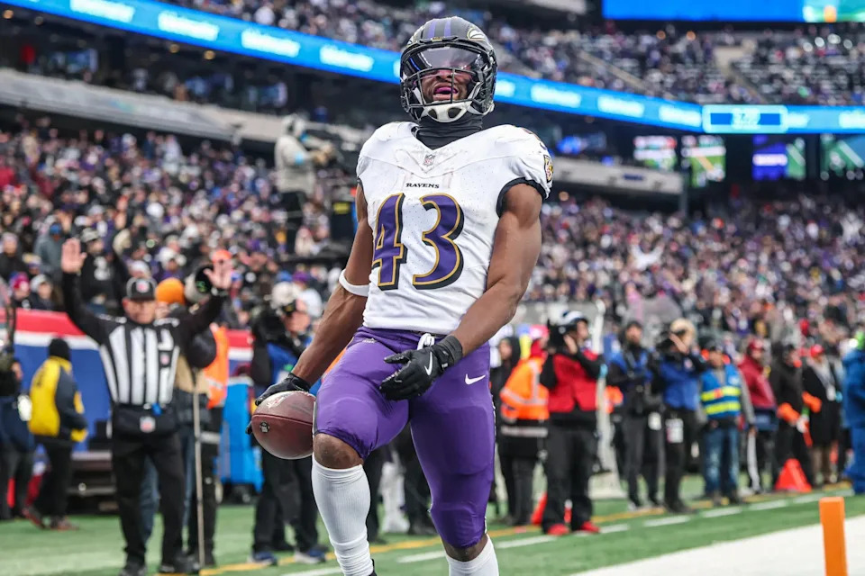 Dec 15, 2024; East Rutherford, New Jersey, USA; Baltimore Ravens running back Justice Hill (43) scores a touchdown reception during the second half against the New York Giants at MetLife Stadium. Mandatory Credit: Vincent Carchietta-Imagn Images