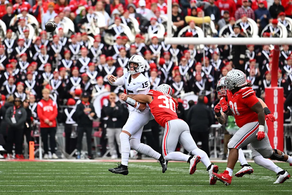COLUMBUS, OHIO - OCTOBER 21: Drew Allar #15 of the Penn State Nittany Lions throws the ball while being tackled by Cody Simon #30 of the Ohio State Buckeyes during the fourth quarter of a game at Ohio Stadium on October 21, 2023 in Columbus, Ohio. (Photo by Ben Jackson/Getty Images)Ben Jackson/Getty Images