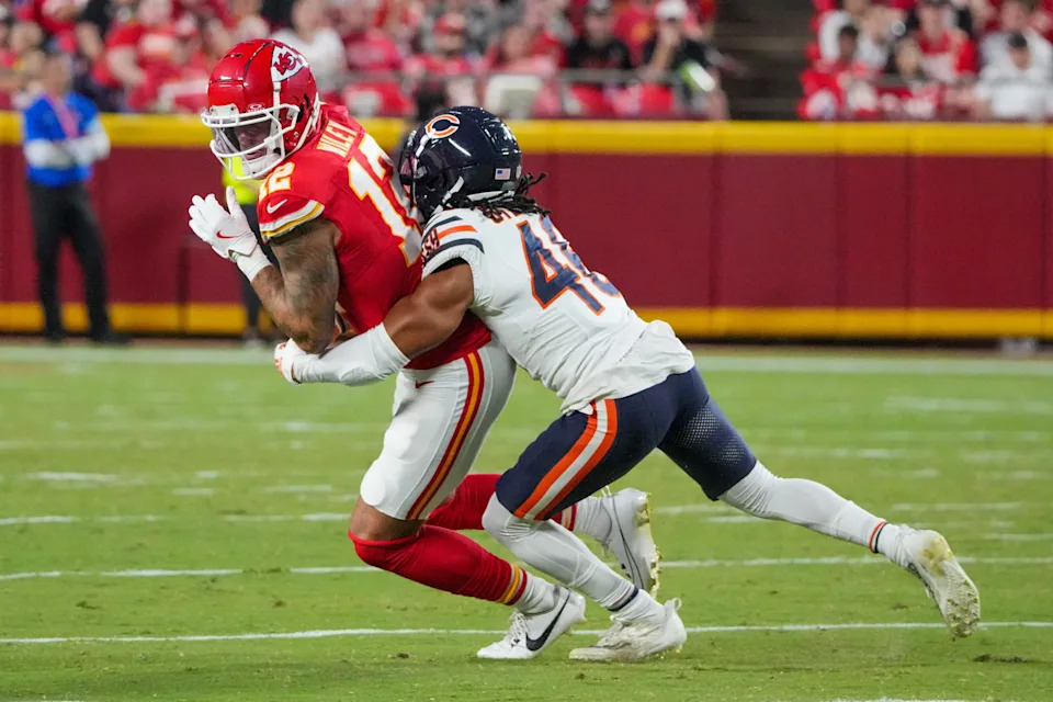 Aug 22, 2024; Kansas City, Missouri, USA; Kansas City Chiefs tight end Jared Wiley (12) catches a pass and is tackled by Chicago Bears cornerback Reddy Steward (46) during the first half at GEHA Field at Arrowhead Stadium. Mandatory Credit: Denny Medley-USA TODAY Sports