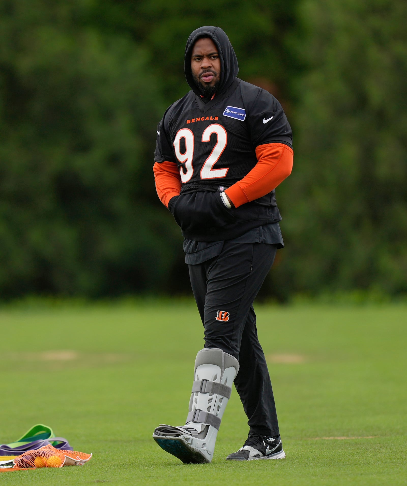 Cincinnati Bengals defensive tackle B.J. Hill (92) walks with a boot on his left leg during NFL football practice, Tuesday, May 6, 2025, in Cincinnati. (AP Photo/Carolyn Kaster)