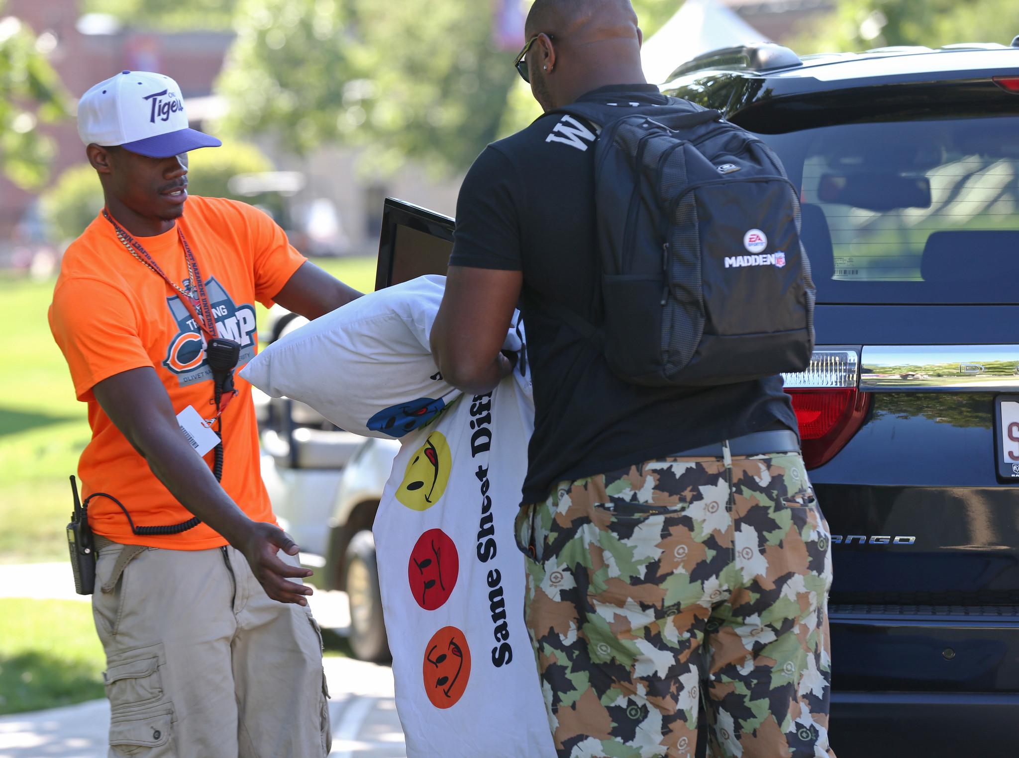 Nate Collins hands off items, including a body pillow that reads: 