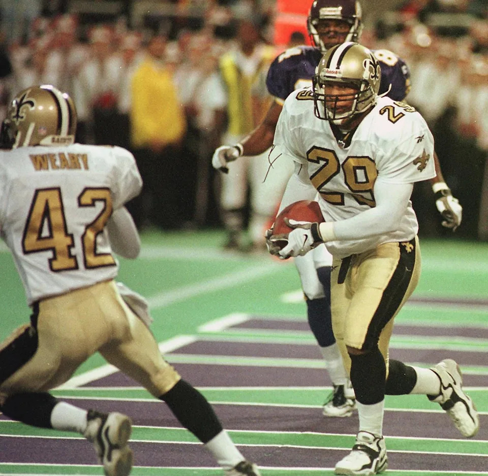 New Orleans Saints' Sammy Knight runs back an interception from the end zone to the Saints' seven yard line 08 November at the Metrodome in Minneapolis, MN. The pass was thrown by Minnesota Viking's Brad Johnson in the final seconds of the first half. Minnesota won 31-24. AFP PHOTO/Craig LASSIG (Photo by CRAIG LASSIG / AFP)  (Photo credit should read CRAIG LASSIG/AFP via Getty Images)