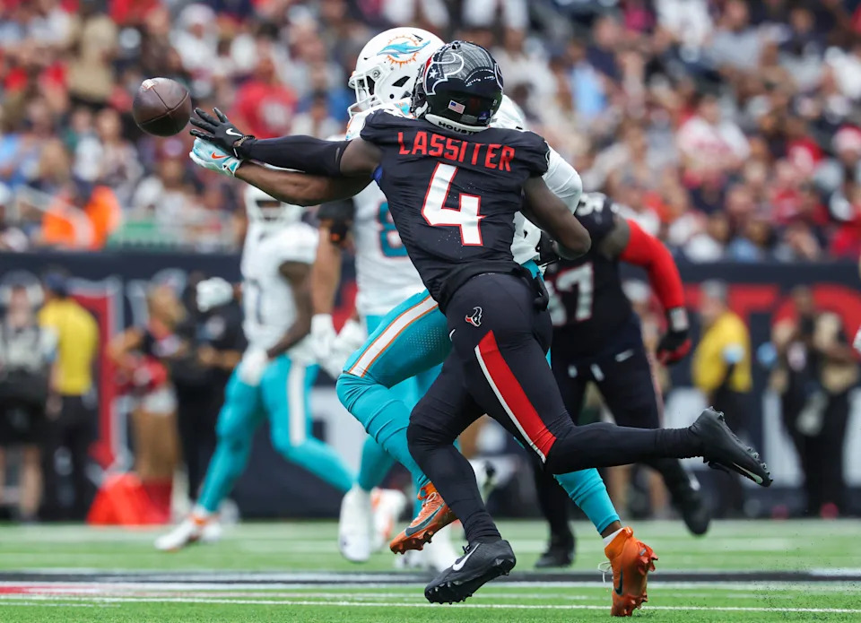 Dec 15, 2024; Houston, Texas, USA; Houston Texans cornerback Kamari Lassiter (4) defends against a pass intended for Miami Dolphins wide receiver Jaylen Waddle (17) during the second quarter at NRG Stadium. Mandatory Credit: Troy Taormina-Imagn Images