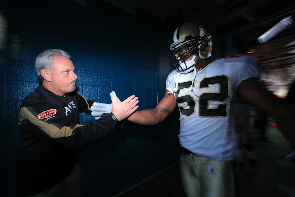MIAMI GARDENS, FL - FEBRUARY 07: Assistant Head Coach Joe Vitt high fives in the tunnel with #52 Jonathan Casillas of the New Orleans Saints prior to Super Bowl XLIV against the Indianapolis Colts on February 7, 2010 at Sun Life Stadium in Miami Gardens, Florida. (Photo by Donald Miralle/Getty Images)