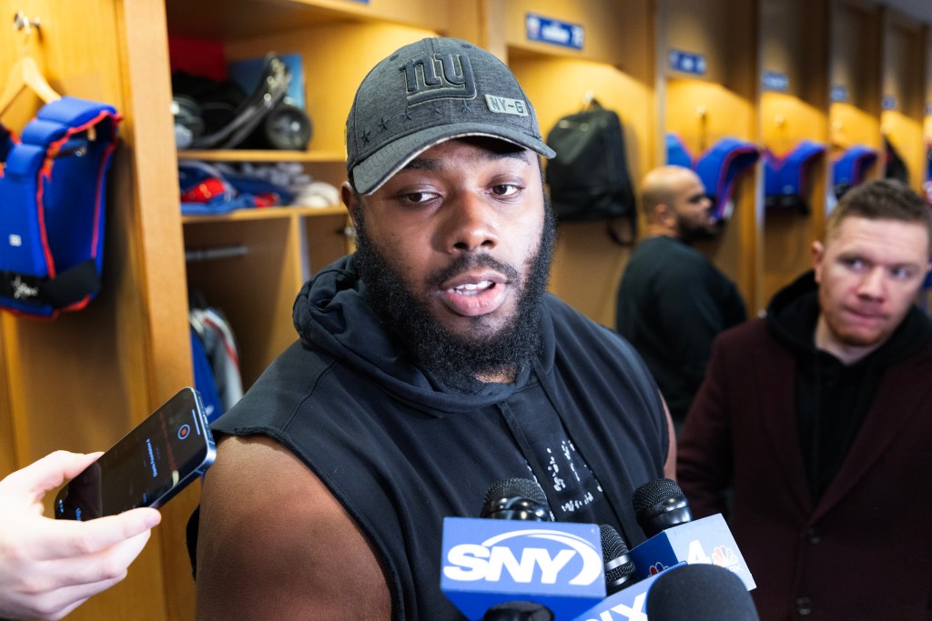 Andrew Thomas #78, speaking to the media in the locker room at the New York Giants training facility in East Rutherford, New Jersey on January 6, 2025.