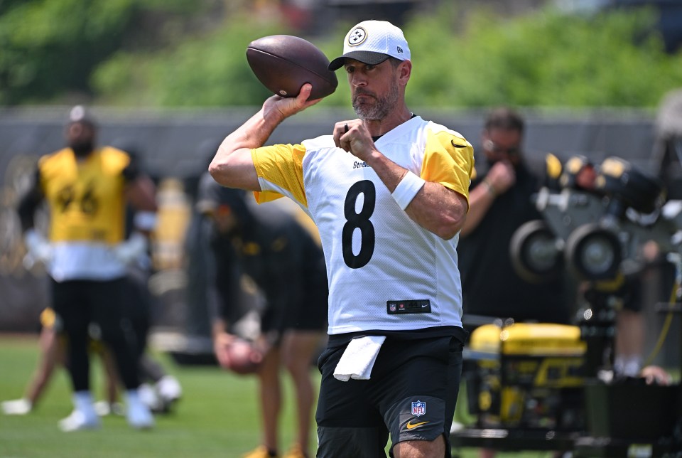 Aaron Rodgers #8 of the Pittsburgh Steelers throwing a football at minicamp.
