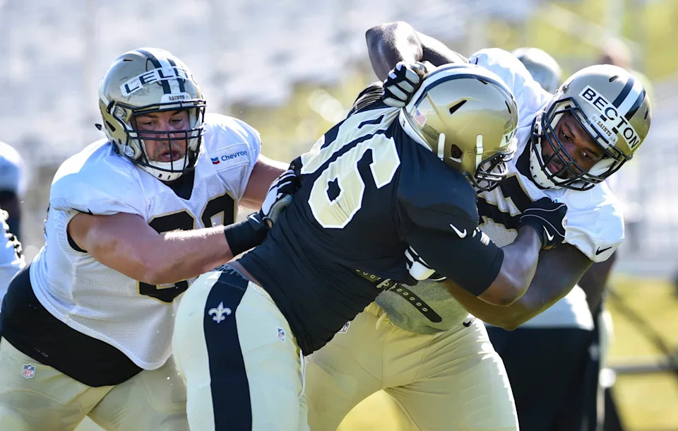 Aug 3, 2015; White Sulphur Springs, WV, USA; New Orleans Saints tackle Nick Becton (67) and guard Tim Lelito (68) block nose tackle Lawrence Virgil (96) at The Greenbrier. Mandatory Credit: Michael Shroyer-USA TODAY Sports
