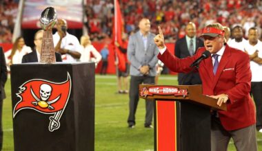 Former Buccaneers HC Jon Gruden receives a 1976 jersey from the team