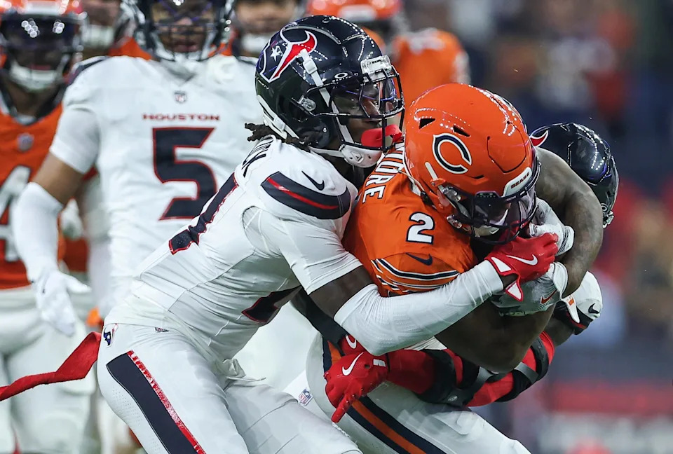 Sep 15, 2024; Houston, Texas, USA; Houston Texans safety Calen Bullock (21) attempts to tackle Chicago Bears wide receiver DJ Moore (2) during the game at NRG Stadium. Mandatory Credit: Troy Taormina-Imagn Images