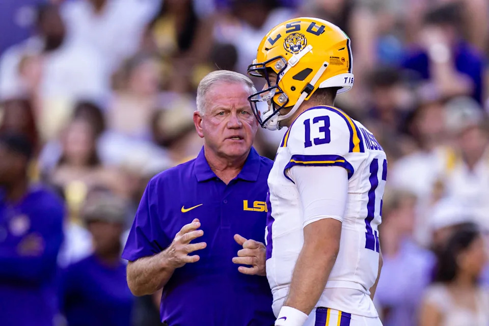 LSU Tigers quarterback Garrett Nussmeier (13) talks to head coach Brian Kelly.Stephen Lew-Imagn Images