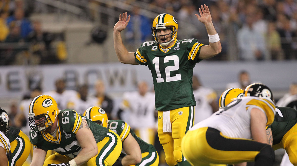 Green Bay Packers quarterback Aaron Rodgers (12) signals at the line of scrimmage against the Pittsburgh Steelers during the second half of Super Bowl XLV at Cowboys Stadium. 
