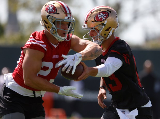 San Francisco 49ers starting quarterback Brock Purdy (13) hands the ball off to San Francisco 49ers' Christian McCaffrey (23) during practice at the 49ers training camp at the practice facility at Levi's Stadium in Santa Clara, Calif., on Wednesday, July 23, 2025. (Nhat V. Meyer/Bay Area News Group)