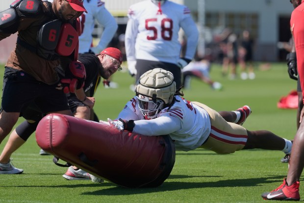 San Francisco 49ers defensive lineman C.J. West, bottom, performs a drill during practice at the team's NFL football training camp, Sunday, July 27, 2025, in Santa Clara, Calif. (AP Photo/Jeff Chiu)
