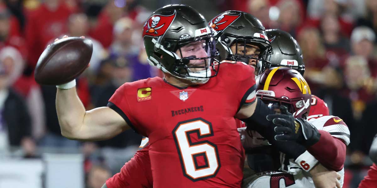 Tampa Bay Buccaneers quarterback Baker Mayfield (6) throws against Washington Commanders linebacker Dante Fowler Jr. (6) during the second quarter of a NFC wild card playoff at Raymond James Stadium.