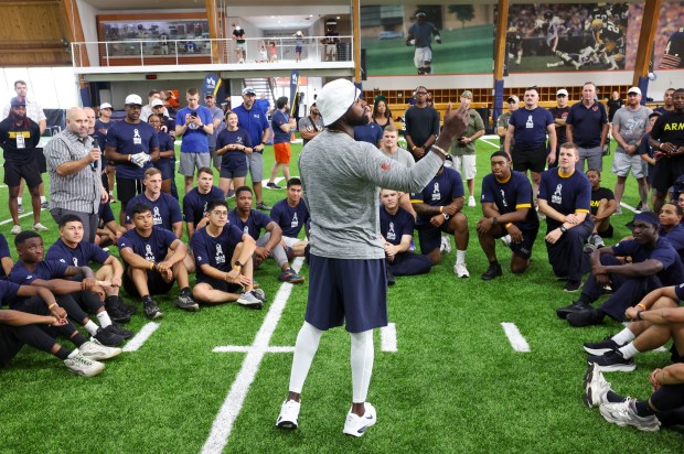 Former Chicago Bear Devin Hester speaks with local military during...