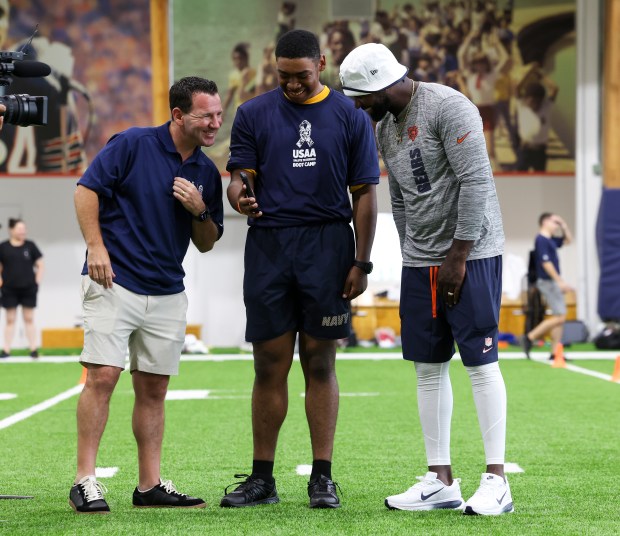 Ian Rapoport, left, and Devin Hester, right, talk to the...