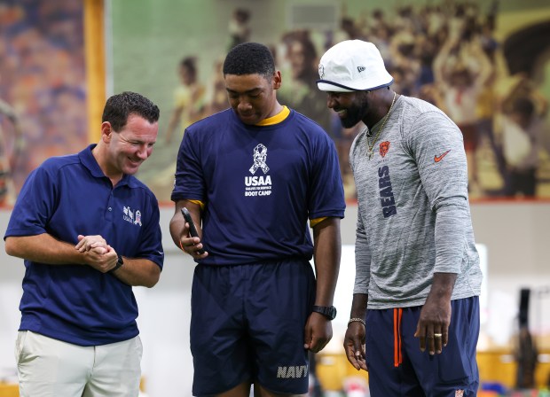 Ian Rapoport, left, and Devin Hester, right, talk to the...